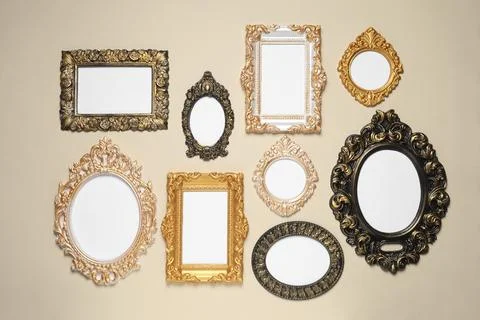 Empty vintage frames hanging on beige wall 写真素材