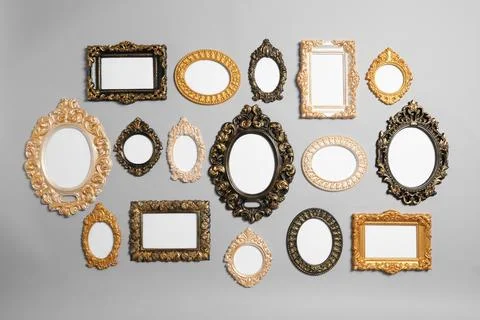 Empty vintage frames hanging on light gray wall Stock Photos