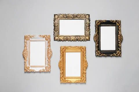 Empty vintage frames hanging on light gray wall Stock Photos