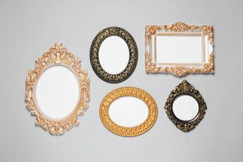 Empty vintage frames hanging on light gray wall Stock Photos