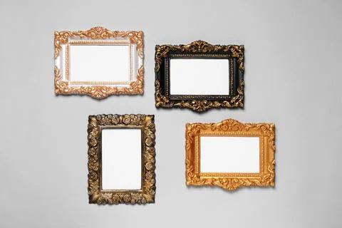 Empty vintage frames hanging on light gray wall Stock Photos