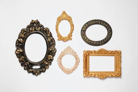 Empty vintage frames hanging on white wall 스톡 사진