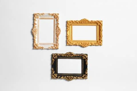 Empty vintage frames hanging on white wall Stock Photos