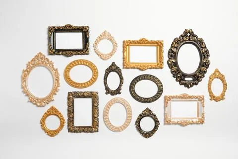 Empty vintage frames hanging on white wall Foto stock