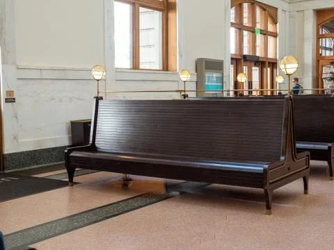 Empty waiting bench at train station terminal awaiting departure train Stock Photos