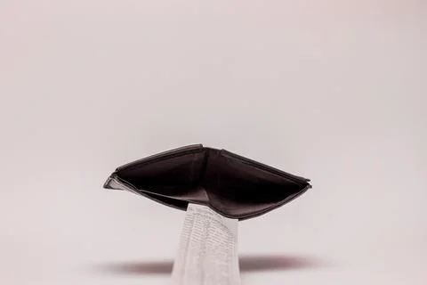 Empty wallet concept caused by big bill Stock Photos
