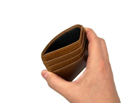 An Empty wallet in the hands of a man isolated on white background, wealth Foto stock