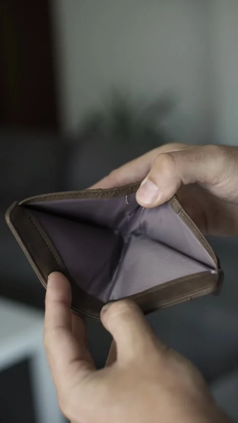 Empty wallet in hands symbolizing debt, poverty, financial hardship, budgetin Stock Footage 342236450