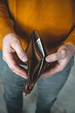Empty wallet in the hands of a young man Stock Photos