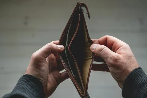 Empty wallet in the hands of a young man Stock Photos