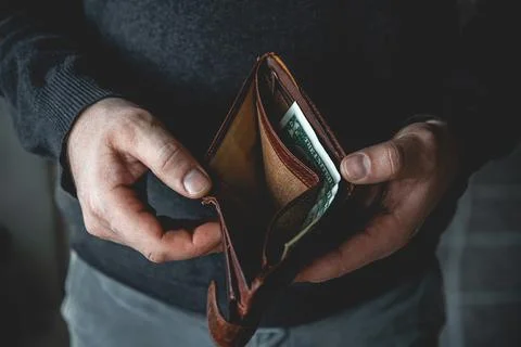 Empty wallet in the hands of a young man Stock Photos