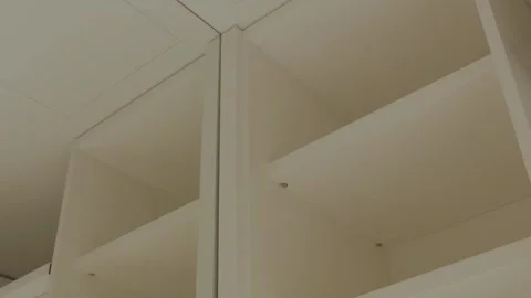 Empty wardrobe shelves as key elements of modern interior design. Vertical shot Video stock 311249847
