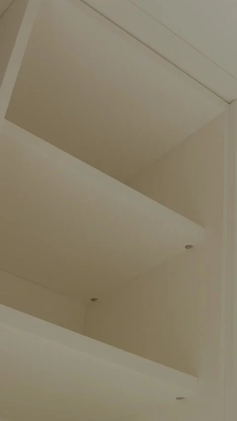 Empty wardrobe shelves as key elements of modern interior design. Vertical shot Video stock 311255794