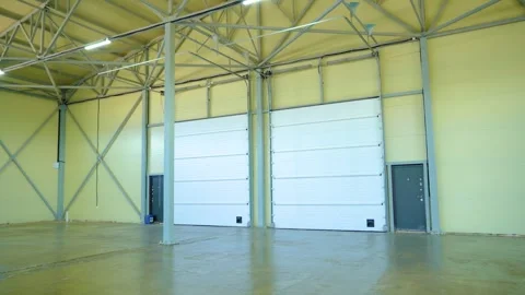 Empty Warehouse Interior With Loading Dock Doors and Steel Structure Stock Footage 340041829