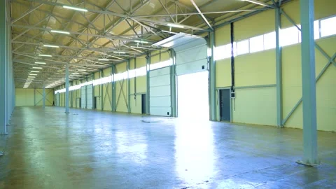 Empty Warehouse Interior With Open Loading Dock Door and Steel Structure Stock Footage 340041813