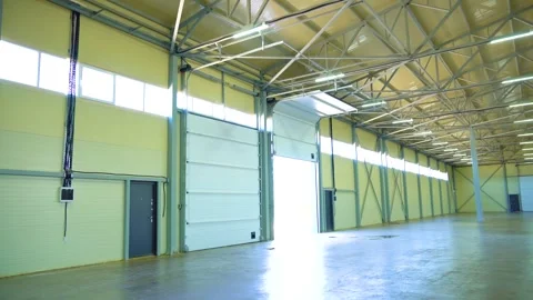 Empty Warehouse Interior With Open Loading Door and Steel Support Columns Stock Footage 340041817