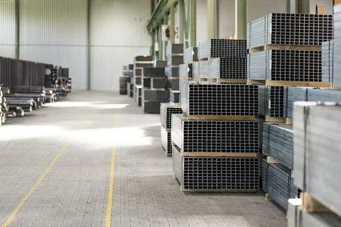 Empty warehouse interior with shelves, pallets, boxes and equipment Stock Photos