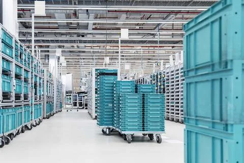 Empty warehouse interior with shelves, pallets, boxes and equipment Stock Photos