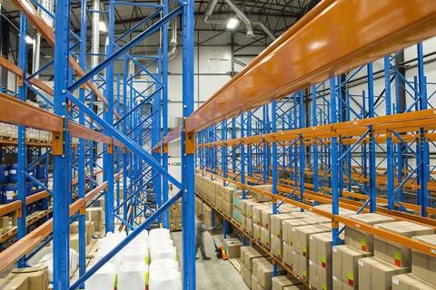Empty warehouse interior with shelves, pallets, boxes and equipment Stock Photos