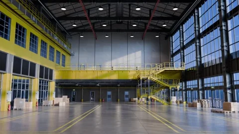 Empty warehouse interior with sunlight shining through windows Video stock 309936675