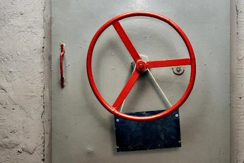 Empty warning sign plate hanging on a hermetic bomb shelter armored door Stock Photos