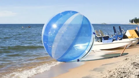 Empty water ball, zorb, on the waves, extreme attraction for beach vacationers Video stock 138160187