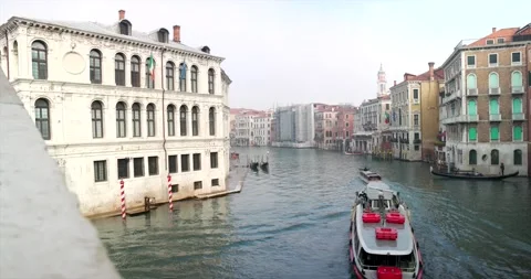 Empty water bus shuttle on grand canal behind a motorboat next to a gondola Video stock 150388305