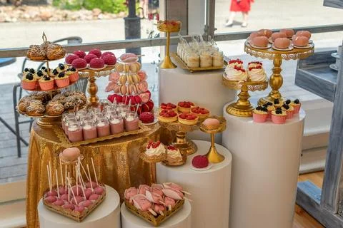 Empty Wedding Reception Dessert Table With Pink and Gold Decorations Stock Photos