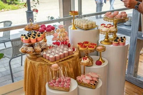 Empty Wedding Reception Hall With Dessert Table Decorated With Pink and Gold Stock Photos