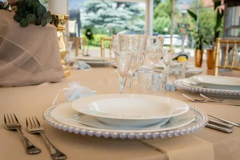 Empty Wedding Reception Hall Table Setting With White Plates and Silverware Stock Photos