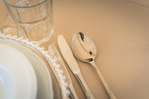 Empty Wedding Reception Hall Table Setting With Silverware and Glass Stock Photos