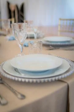 Empty Wedding Reception Table Setting With Plates, Glasses, and Silverware Stock Photos