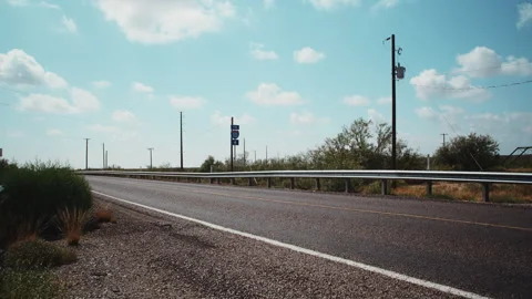 Empty West Texas Highway Under Blue Sky with Passing Clouds – 4K Video stock 320849941