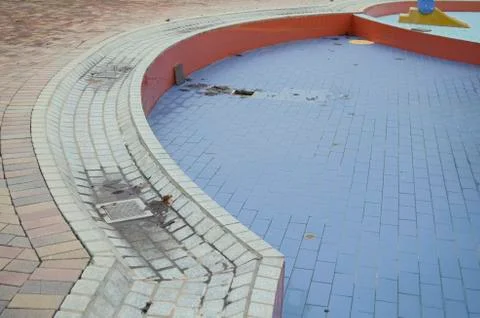 Empty wet swimming pool with leafs Stock Photos