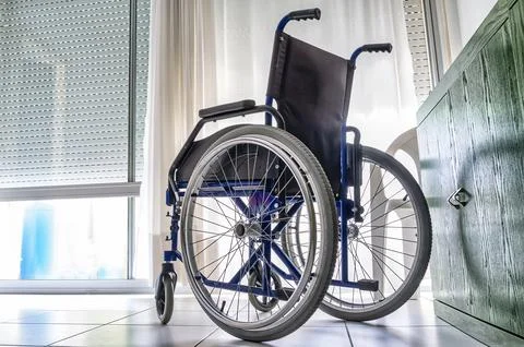Empty wheelchair inside a room Stock Photos