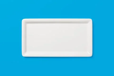 Empty white angular plate on blue background, clipping-path Stock Photos