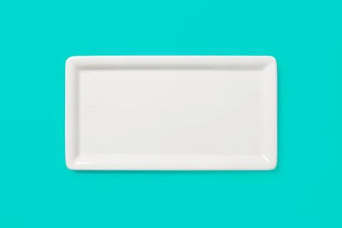 Empty white angular plate on green background, clipping-path Stock Photos