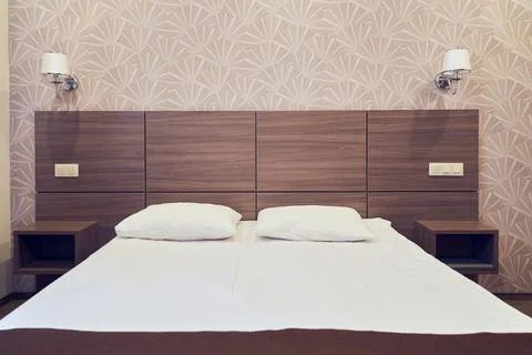 An empty white bed with a place for your design. The concept of clean bed linen Stock Photos