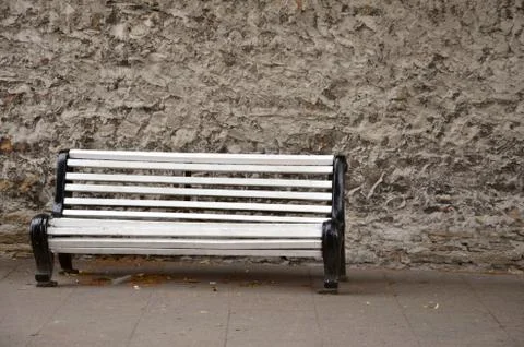 Empty white bench in front of wall Stock Photos