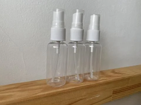 Empty white bottle spray container on the table Stock Photos