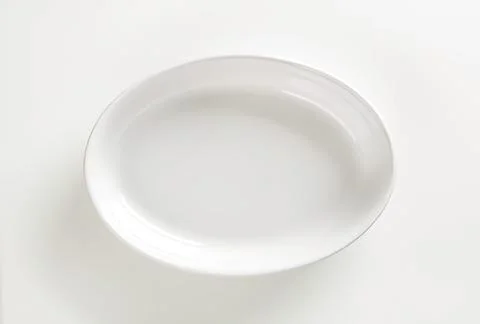 Empty white bowl on plain surface Stock Photos