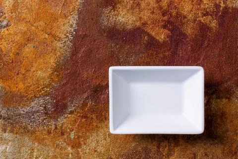 Empty white bowl on rusty background Stock Photos
