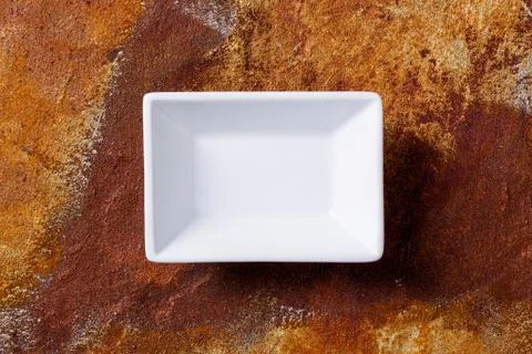 Empty white bowl on rusty background Stock Photos