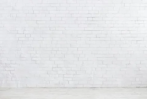 Empty white brick wall with concrete floor in a room Stock Photos