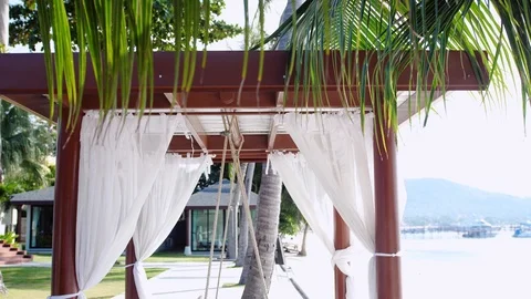 Empty white canopy swing or patio swing by the beach. slow motion. 3840x2160 Stock Footage 91716266