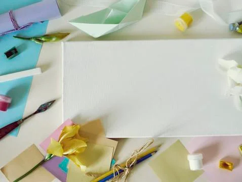 Empty white canvas, art materials, fresh flowers Stock Photos
