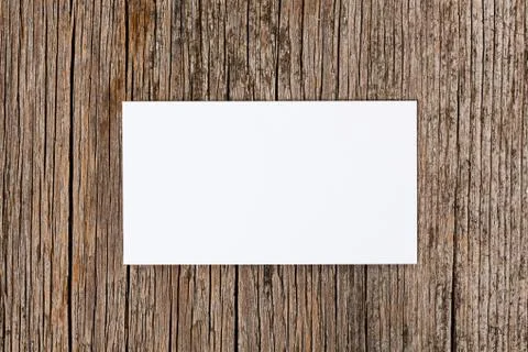 Empty white card over old textured wooden background Stock Photos
