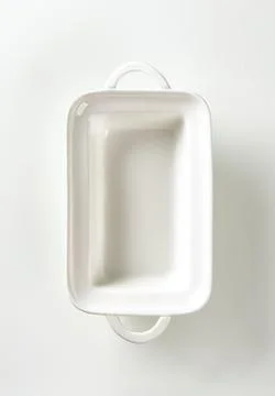 Empty white ceramic baking dish hanging Stock Photos