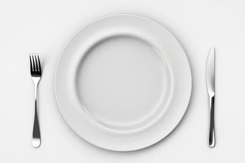 Empty white ceramic plate with fork and knife on light table. Top view. Foto stock