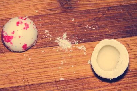 The empty white chewing gum is cut in half with a kitchen knife. Stock Photos
